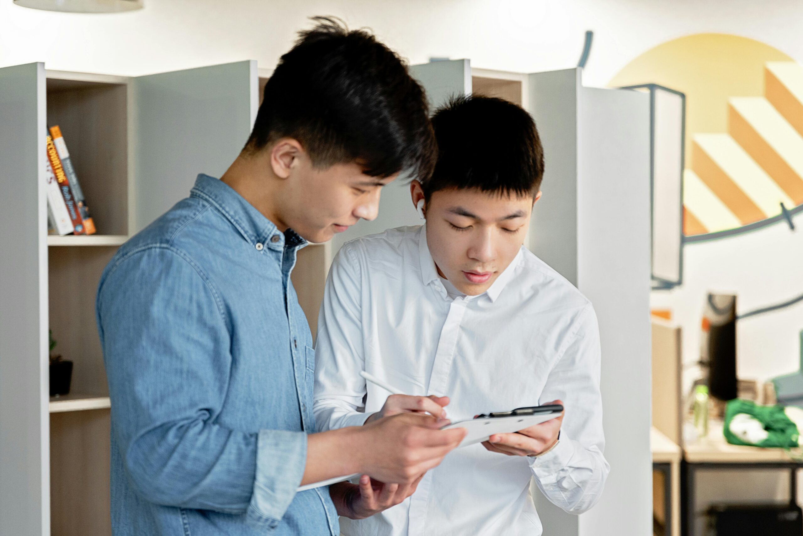 Men Looking at a Gadget while Working